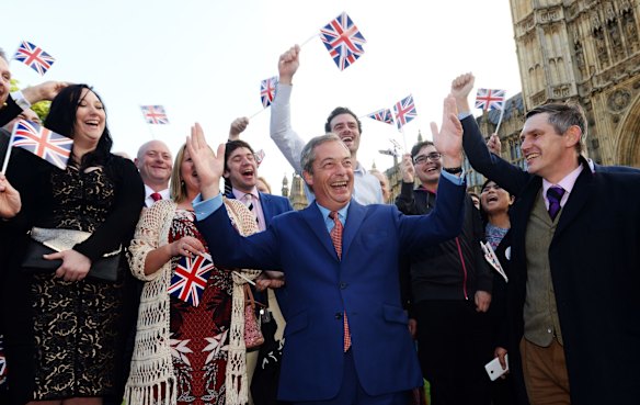 Nigel Farage, the leader of the UK Independence Party celebrates with his supporters in London.