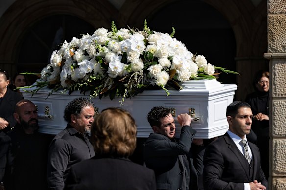 Pallbearers carry Lametta Fadlallah's coffin to the church.
