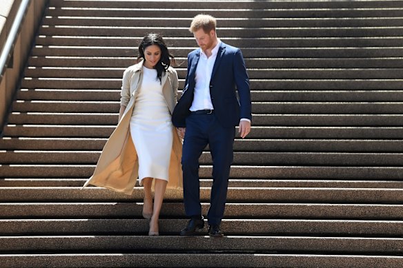 Britain's Prince Harry, the Duke of Sussex, and his wife Meghan, the Duchess of Sussex, arrive for a meet the people walk at the Sydney Opera House in Sydney, Australia, Tuesday, October 16, 2018. The Duke and Duchess of Sussex are on a 3-week tour of Australia, New Zealand, Tonga, and Fiji and are in Sydney to launch the 2018 Invictus Games, an Olympic-style event for disabled and ill service people. (AAP Image/Joel Carrett) NO ARCHIVING