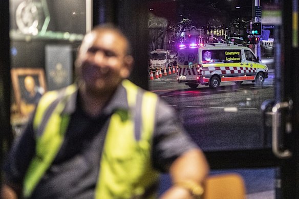 An ambulance hoping for a quiet night is pictured through a window of the Surry Hills Hotel in Sydney.