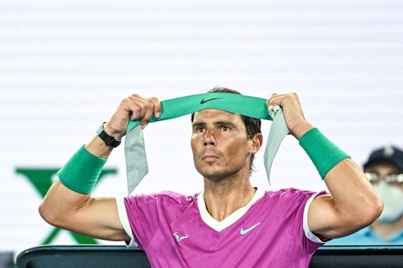 Rafael Nadal applies a fresh headband during his match against Matteo Berretini.