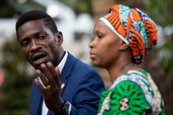 Bobi Wine addresses the media as security forces surround his home.