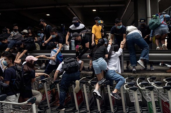 Protesters flee as riot police advance during a rally at  the Hong Kong International Airport on September 1, 2019 in Hong Kong, China. 