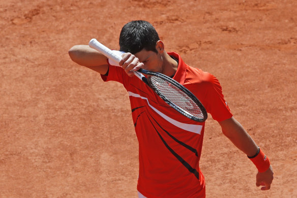 Serbia's Novak Djokovic wipes his forehead during the men's semi-final match.