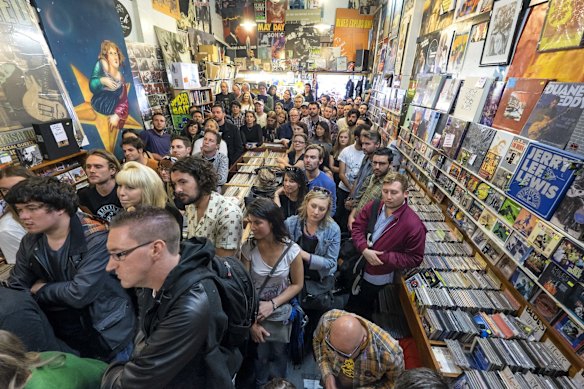 People listen as Paul Kelly performs with Vika and Linda at Greville Records as part of World Record Day celebrations on April 18, 2015 in Melbourne, Australia.  