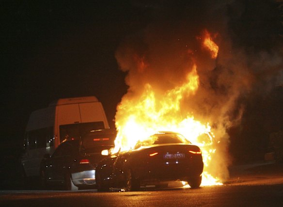 A car burns during a firefight between the Turkish army and the Turkish police in Istanbul's Taksim square.