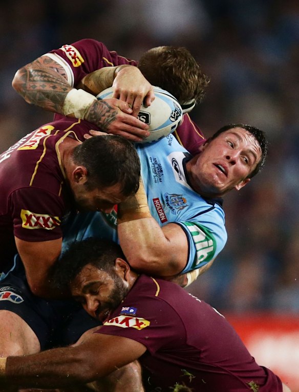 Josh Jackson of the Blues is tackled.