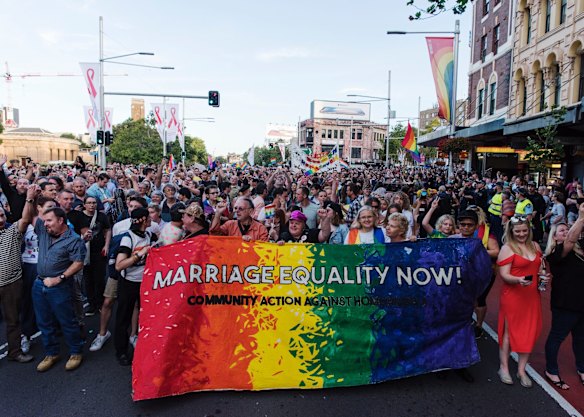 Crowds march down Oxford St, Darlinghurst this evening to celebrate the majority yes vote of the results of the postal vote.