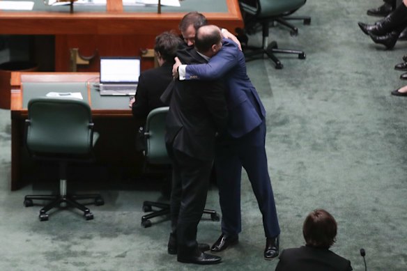 Minister for Environment and Energy Josh Frydenberg embraces Labor MP Ed Husic after he spoke in the House of Representatives in response to Senator Fraser Anning's first speech in the Senate, at Parliament House in Canberra on Wednesday.