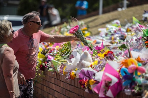 A couple pay their respects at Dreamworld where four people died after a malfunction with the 'Thunder River Rapids' at the theme park on October 27, 2016 in Gold Coast, Australia. 