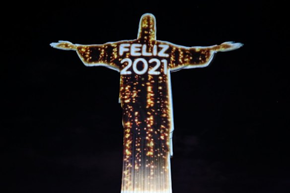 Iluminated statue of Christ the Redeemer written Happy 2021 in Rio de Janeiro, Brazil.