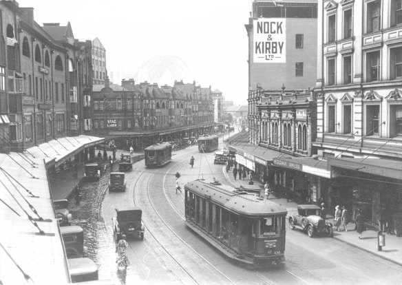 View of George Street from Grosvenor Street, looking northward to the Sydney Harbour Bridge that is under construction, 1931


