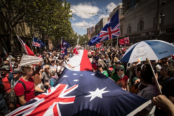 Protesters walk down Bourke Street on November 27, 2021 in Melbourne, Australia. 
