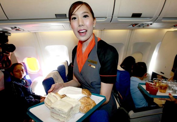 Thai transsexual flight attendant Phuntakarn Sringern serves food during the flight.