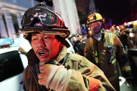 A member of the Fire Department radios to colleagues following an explosion at the Ratchaprasong intersection in Bangkok, Thailand, on Monday, Aug. 17, 2015. 