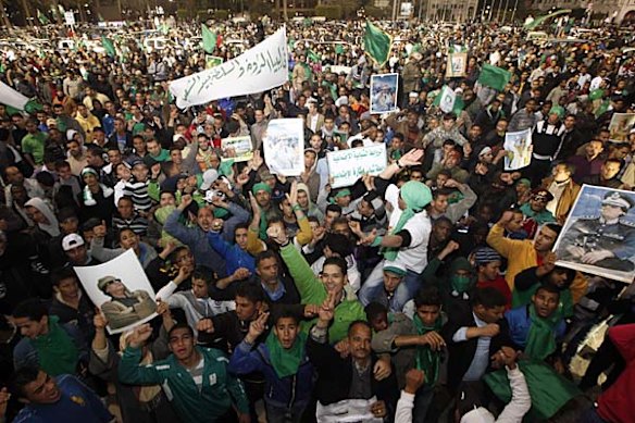 Supporters of Libyan leader Moamer Kadhafi take part in a pro-government rally in Tripoli after an opposition "day of anger" turned into a bloodbath.