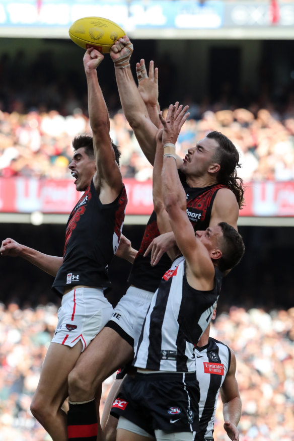 Brandon Zerk-Thatcher (left) and Sam Draper of Essendon spoil Ash Johnson of Collingwood.