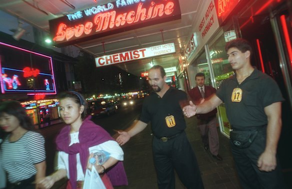 John (centre) and Emanouel (right) outside the Love Machine in Kings Cross where they work as spruikers. 20th February 1995.