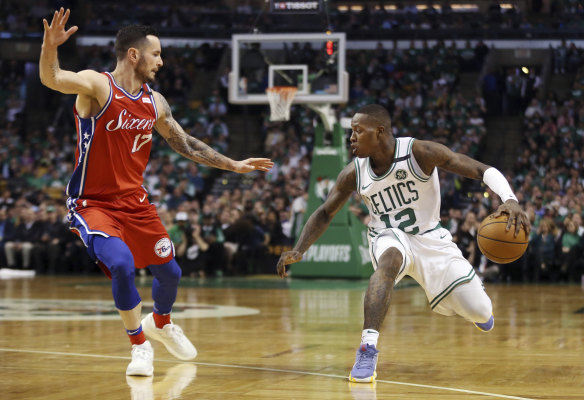 Terry Rozier makes a move against JJ Redick.