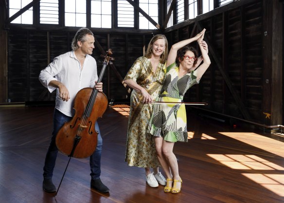 Leigh Sales and Annabel Crabb, with Australian Chamber Orchestra cellist Julian Thompson and baritone cello (nicknamed Barry) at the ACO’s harbourside headquarters in Walsh Bay, Sydney.