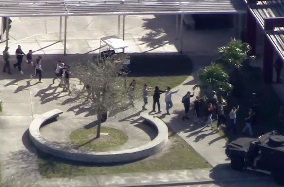 In this frame grab from video provided by WPLG-TV, students from the Marjory Stoneman Douglas High School in Parkland, Fla., evacuate the school following a shooting.