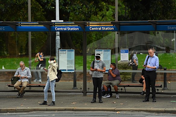 Commuters wait for buses near Central Station on Monday.