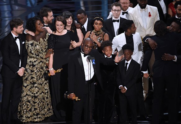 Barry Jenkins, foreground centre, and the Moonlight cast accept the award for best picture.