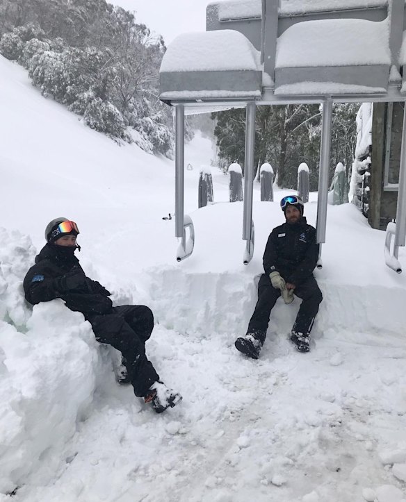 Resort staff at a snowed-in ski lift at Mount Buller after heavy falls over the past week. 