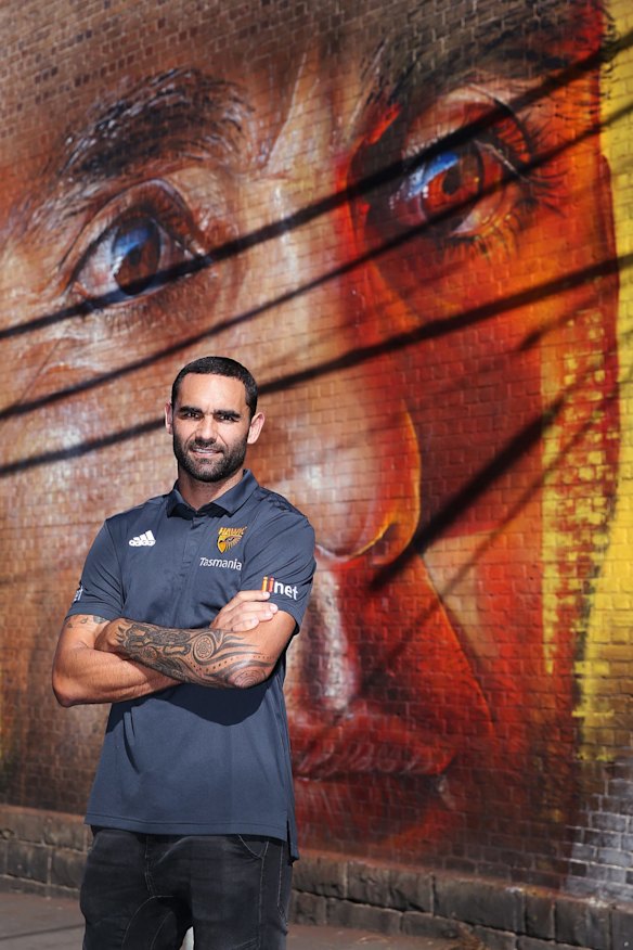 2019 Shaun Burgoyne poses in front of his a street art portrait of himself.