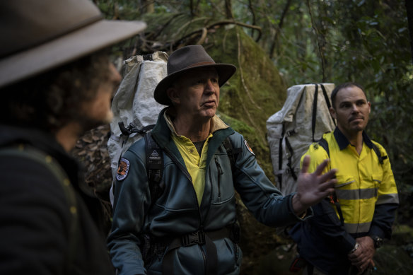 David Crust (centre), the director of the Blue Mountains division of the NSW National Parks and Wildlife Service, discusses replanting efforts for the Wollemi pine, with Berin Mackenzie (right) a parks ecologist and Atticus Fleming, deputy secretary of the service.