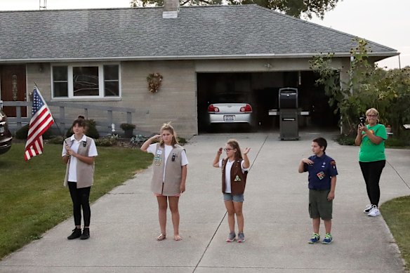 Supporters of President of Donald Trump on the street wave to the motorcade during the official opening of businessman Anthony Pratt's Pratt Industries Wapakoneta recycling and paper plant in Wapakoneta, Ohio.