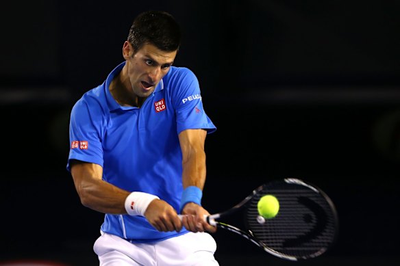 MELBOURNE, AUSTRALIA - FEBRUARY 01:  Novak Djokovic of Serbia plays a backhand in his men's final match against Andy Murray of Great Britain during day 14 of the 2015 Australian Open at Melbourne Park on February 1, 2015 in Melbourne, Australia.  