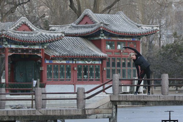 Foreign Minister Julie Bishop stretches before jogging at Ritan Park in Beijing in 2016.
