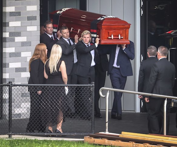The coffin of Shane Warne is carried out by his son Jackson watched by his daughters Summer and Brooke. 
