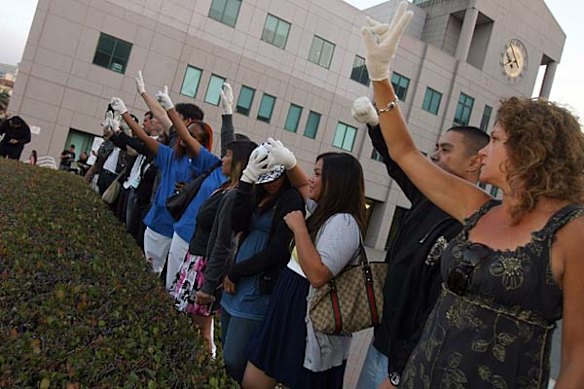 People wear white gloves to honor Michael Jackson who passed away today at UCLA Medical Plaza in Los Angeles, California.