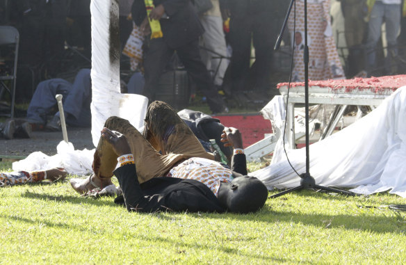 Injured people lay on the ground following the explosion. 