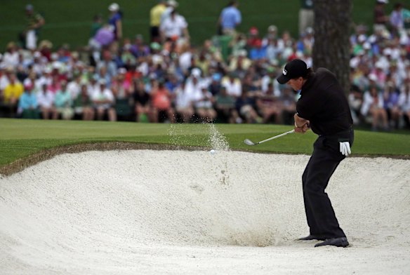 Phil Mickelson hits out of a bunker on the 15th.