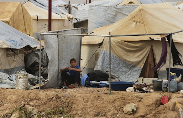 A young male sits outside a tent in the foreign annex in Al-Hawl camp in North East Syria. 