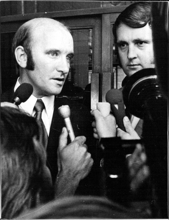 Then senior detective Brian Murphy, left, and constable Carl Stillman speak to the press in March 1972, after a Melbourne court acquitted them over the death in custody of Neil Collingburn. 