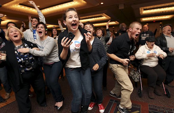 Supporters of President  Barack Obama cheer as Obama wins their state, at a victory party in Manchester,  New Hampshire.