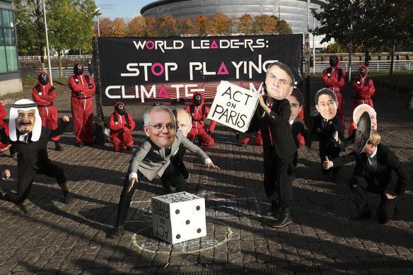 Climate campaigners wearing masks of world leaders enact a “Squid Game” themed protest stunt with campaigners wearing masks of Australia’s Prime Minister Scott Morrison, centre left, and Brazilian President Jair Bolsonaro, centre right, on the fringes of the COP26 UN Climate Summit, in Glasgow, Scotland.