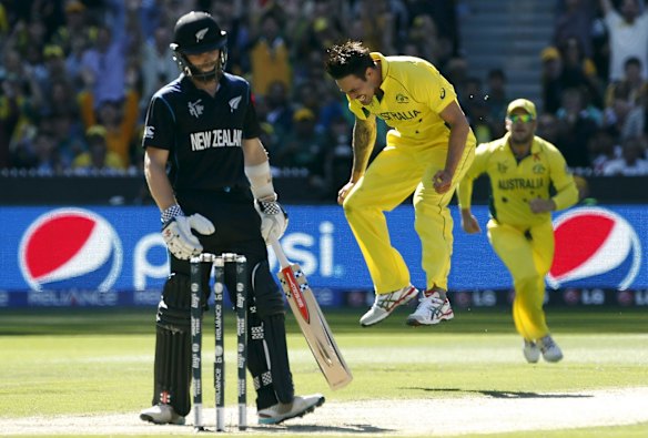 Australia's Mitchell Johnson (C) reacts after catching out New Zealand's Kane Williamson (L) for twelve runs during their Cricket World Cup final match at the Melbourne Cricket Ground (MCG) March 29, 2015.   
