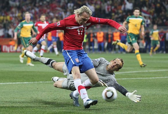 Milos Krasic of Serbia attempts to round Mark Schwarzer during their 2010 FIFA World Cup Group D match.