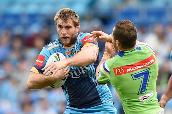  Ryan Simpkins of the Titans takes on the defence.