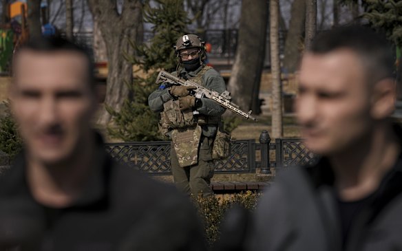 Kyiv Mayor Vitali Klitschko (right) under heavy guard during a press conference next to his brother, former heavyweight boxing world champion Wladimir Klitschko.