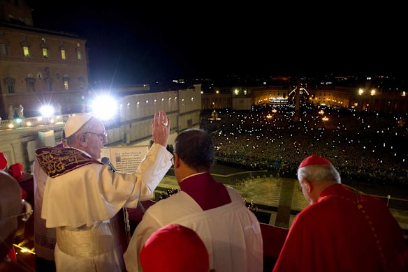 Newly elected Pope Francis I appears on the central balcony of St Peter's Basilica.
