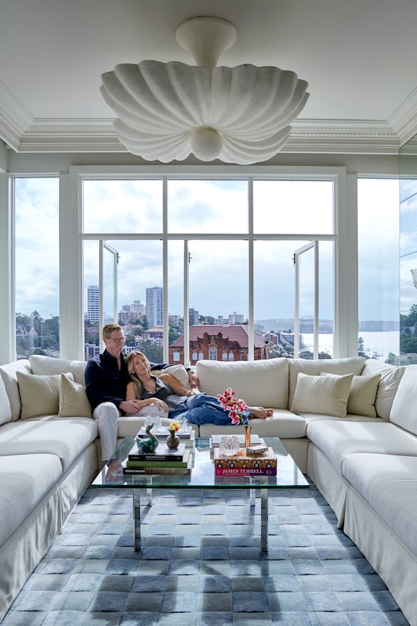 Owners Shona McElroy and Hamish Cooke on a bespoke lounge anchored by a Smac x Hali “Vicenza” rug designed by McElroy.