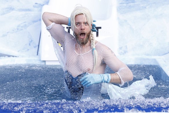 Hamish Blake, Australian comedian, goes down the slide as Disney Princess, Elsa. 