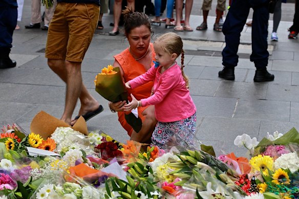 Members of the public lay flowers at Martin Place on Tuesday. 