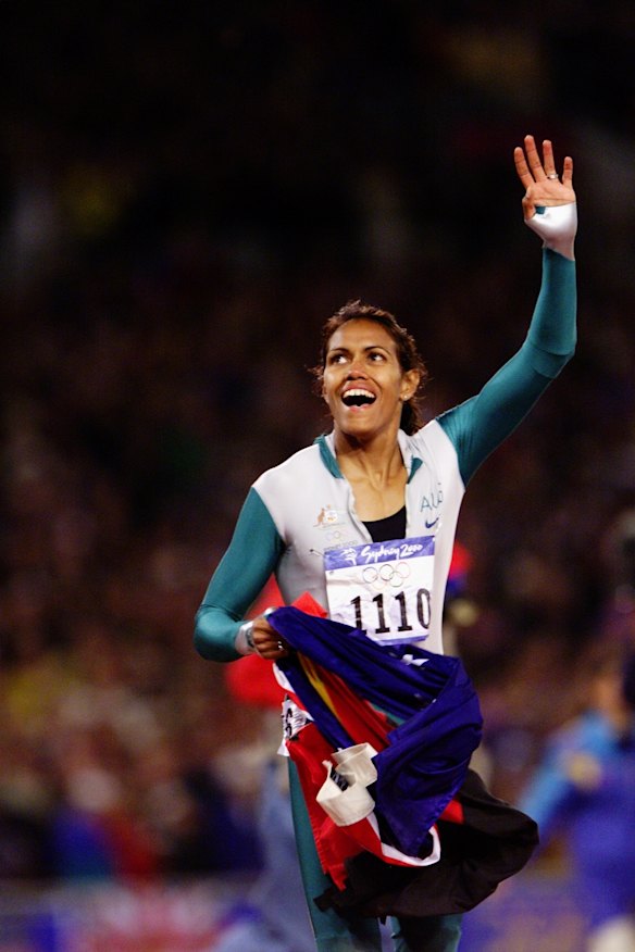 Cathy Freeman celebrates after winning the 400 metre final in front of 110,000 people and millions watching on television in Sydney Olympic Park in September 2000.